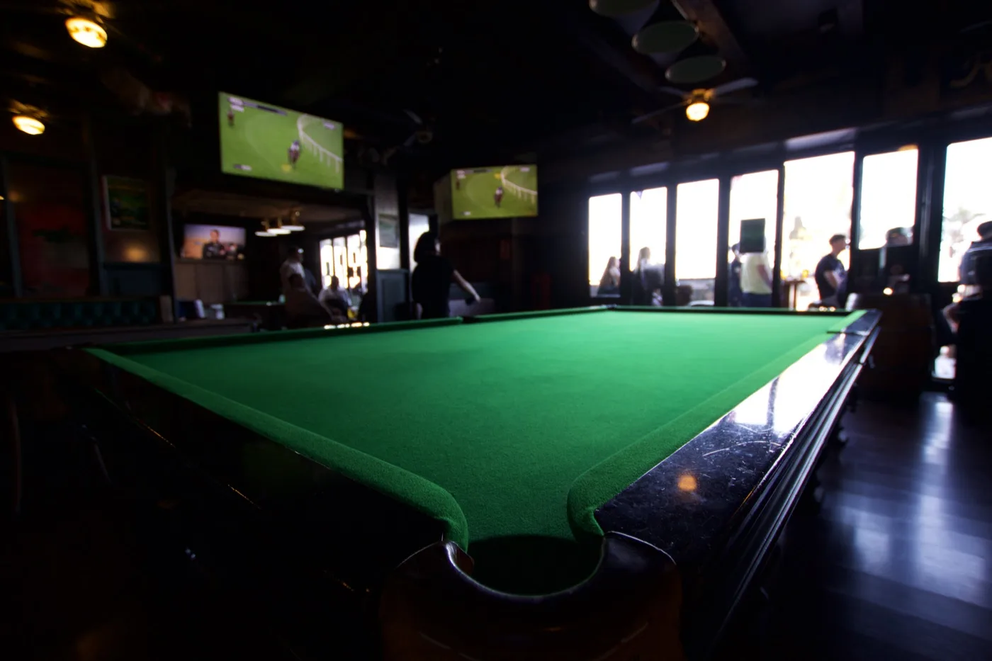 Snooker table with sports on the screens